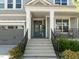 Inviting front entrance with a teal-colored door, decorative sidelights, and a covered porch at 98 Stone Bridge Xing # 98, Chapel Hill, NC 27517