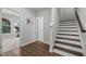 Inviting hallway with hardwood floors leading to a staircase and sunlit rooms at 98 Stone Bridge Xing # 98, Chapel Hill, NC 27517