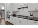 Well-equipped kitchen featuring stainless appliances, white cabinets, and a subway tile backsplash at 98 Stone Bridge Xing # 98, Chapel Hill, NC 27517