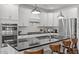 Modern kitchen with black countertops, white cabinets, and stainless steel appliances at 98 Stone Bridge Xing # 98, Chapel Hill, NC 27517