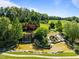 Serene landscaping featuring mature trees, waterfalls, flowing water, and manicured lawn at 98 Stone Bridge Xing # 98, Chapel Hill, NC 27517