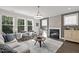 Cozy living room featuring a fireplace, stylish decor, ample natural light, and wood flooring at 98 Stone Bridge Xing # 98, Chapel Hill, NC 27517