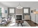 Comfortable living room featuring a fireplace, stylish decor, ample natural light, and wood flooring at 98 Stone Bridge Xing # 98, Chapel Hill, NC 27517