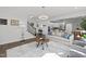 Open-concept living area with a cozy couch, fluffy rug, and stairway access to the second floor at 98 Stone Bridge Xing # 98, Chapel Hill, NC 27517