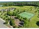 Aerial view of neighborhood tennis courts and playground beside a lush green golf course in a Gathering friendly community at 98 Stone Bridge Xing # 98, Chapel Hill, NC 27517