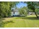 View of backyard and side of the house with garbage bins at 1006 E Harnett St, Dunn, NC 28334