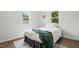 Cozy bedroom featuring natural light, wood-look flooring, and a comfortable bed with stylish decor at 1006 E Harnett St, Dunn, NC 28334