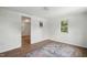Bright bedroom features wood-look flooring, neutral walls, and a view into an adjoining room at 1006 E Harnett St, Dunn, NC 28334