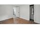 Bedroom featuring wood floors and a closet with shelving and hanging storage at 1006 E Harnett St, Dunn, NC 28334