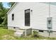 Exterior angle of the home with a storm door and meter box at 1006 E Harnett St, Dunn, NC 28334