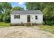 Charming single-story home featuring a freshly painted exterior, new steps, and well-maintained landscaping at 1006 E Harnett St, Dunn, NC 28334