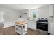 Bright kitchen with modern stainless steel appliances, white cabinets, and wood-look flooring at 1006 E Harnett St, Dunn, NC 28334
