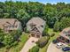 Beautiful aerial view of a two-story home with a stone facade, a well-manicured lawn, and a two-car garage at 104 Bellagio Dr, Apex, NC 27539