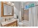 Bathroom with a vanity, framed mirror, and bathtub with tiled walls at 104 Bellagio Dr, Apex, NC 27539