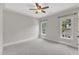 Bedroom featuring neutral paint, carpeting, and large windows providing great natural light at 104 Bellagio Dr, Apex, NC 27539