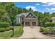 Charming two-story home featuring a stone facade and a well-manicured lawn and a two car garage at 104 Bellagio Dr, Apex, NC 27539