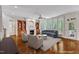 Bright living room featuring fireplace, built-ins, bay windows, and hardwood flooring at 104 Bellagio Dr, Apex, NC 27539