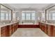 Luxurious main bathroom with dual vanities, a soaking tub, and columns for a spa-like experience at 104 Bellagio Dr, Apex, NC 27539
