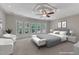 Bright bedroom featuring many windows, a ceiling fan, and neutral colors for a relaxing atmosphere at 104 Bellagio Dr, Apex, NC 27539