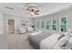 Bright bedroom featuring many windows, a ceiling fan, and neutral colors for a relaxing atmosphere at 104 Bellagio Dr, Apex, NC 27539