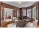 Traditional office with rich wood paneling, desk and bright natural light; view of entryway at 104 Bellagio Dr, Apex, NC 27539