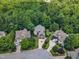 Neighborhood aerial view showcasing lush landscapes, mature trees, and well-maintained homes in a serene setting at 104 Bellagio Dr, Apex, NC 27539
