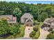 Beautiful aerial view of a two-story home featuring a two-car garage and lush landscaping in a desirable neighborhood at 104 Bellagio Dr, Apex, NC 27539