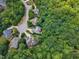 Serene aerial view of homes nestled among lush green trees in a quiet neighborhood cul-de-sac at 104 Bellagio Dr, Apex, NC 27539