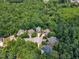 Extensive aerial view showcasing lush landscapes, mature trees, and well-maintained homes in a serene setting at 104 Bellagio Dr, Apex, NC 27539