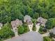 Neighborhood aerial view showcasing lush landscapes, mature trees, and well-maintained homes in a serene setting at 104 Bellagio Dr, Apex, NC 27539