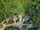 Broad aerial view showcasing lush landscapes, mature trees, and well-maintained homes in a serene neighborhood at 104 Bellagio Dr, Apex, NC 27539