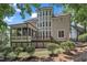 Rear of home featuring a screened in porch, deck, and detailed architectural design at 104 Bellagio Dr, Apex, NC 27539