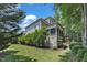 Back exterior view showcasing the screened porch, lush lawn, and landscaping at 104 Bellagio Dr, Apex, NC 27539