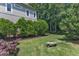 Spacious backyard with lush green grass, mature trees, and serene setting at 104 Bellagio Dr, Apex, NC 27539