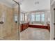 Spacious bathroom with a walk-in shower, soaking tub, double vanities, and neutral tile at 104 Bellagio Dr, Apex, NC 27539