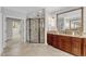 Elegant bathroom featuring a glass shower, granite countertop, and a large decorative mirror at 104 Bellagio Dr, Apex, NC 27539