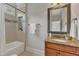 Bathroom featuring a granite countertop vanity and a shower-tub combination at 104 Bellagio Dr, Apex, NC 27539