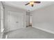 Neutral carpeted bedroom with double closets, ceiling fan and crown moulding at 104 Bellagio Dr, Apex, NC 27539