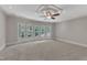 Spacious carpeted bedroom with decorative molding, a ceiling fan, and large windows at 104 Bellagio Dr, Apex, NC 27539