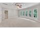 Bright bedroom with ample natural light from large windows and neutral carpeting at 104 Bellagio Dr, Apex, NC 27539