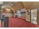 Large bonus room with themed decor and carpet, including a small kitchenette at 104 Bellagio Dr, Apex, NC 27539