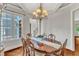 A formal dining room showcasing custom ceiling, chandelier, wood floors and trim at 104 Bellagio Dr, Apex, NC 27539