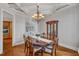 A dining room featuring decorative lighting, custom ceiling, wood flooring, and a wooden china cabinet at 104 Bellagio Dr, Apex, NC 27539