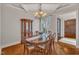 A dining room with an oval table, wood floors, and a china cabinet at 104 Bellagio Dr, Apex, NC 27539