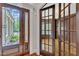 Foyer featuring double doors and view into an office with wood paneling at 104 Bellagio Dr, Apex, NC 27539