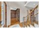 Foyer with hardwood floors and decorative door to a wood-paneled office at 104 Bellagio Dr, Apex, NC 27539