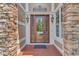 Elegant front door with decorative glass and ironwork, framed by stone columns at 104 Bellagio Dr, Apex, NC 27539