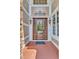 Ornate wooden front door with glass and decorative ironwork accents at 104 Bellagio Dr, Apex, NC 27539