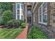 Close-up of the stone front entrance with a walkway and lush landscaping at 104 Bellagio Dr, Apex, NC 27539