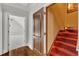 Hallway features hardwood floors, detailed molding, and staircase with access to bonus room at 104 Bellagio Dr, Apex, NC 27539